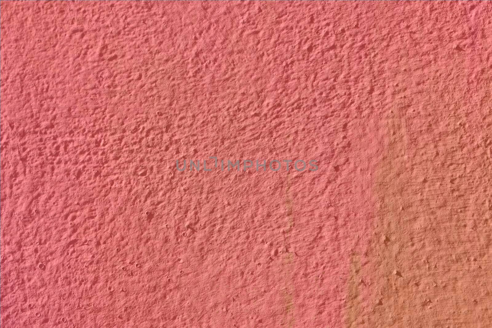 Texture background in pastel pink with a non-uniform surface