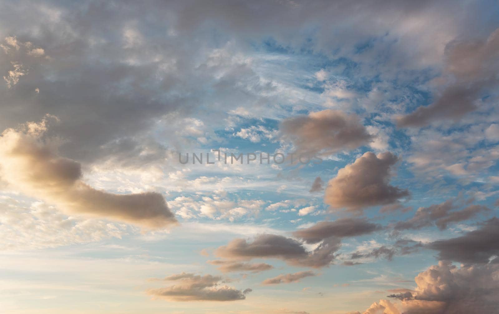 Evening sky with some yellow, white, grey and dark clouds by Ivanko
