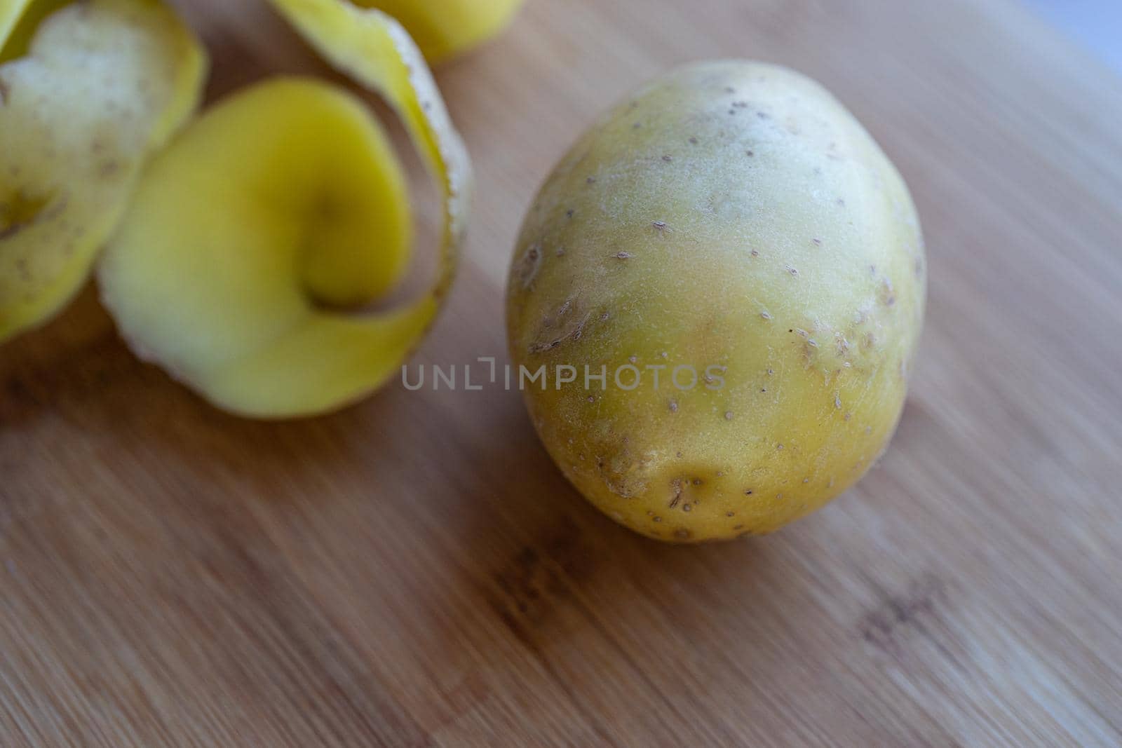 Raw potatoes with peel on a cutting Board