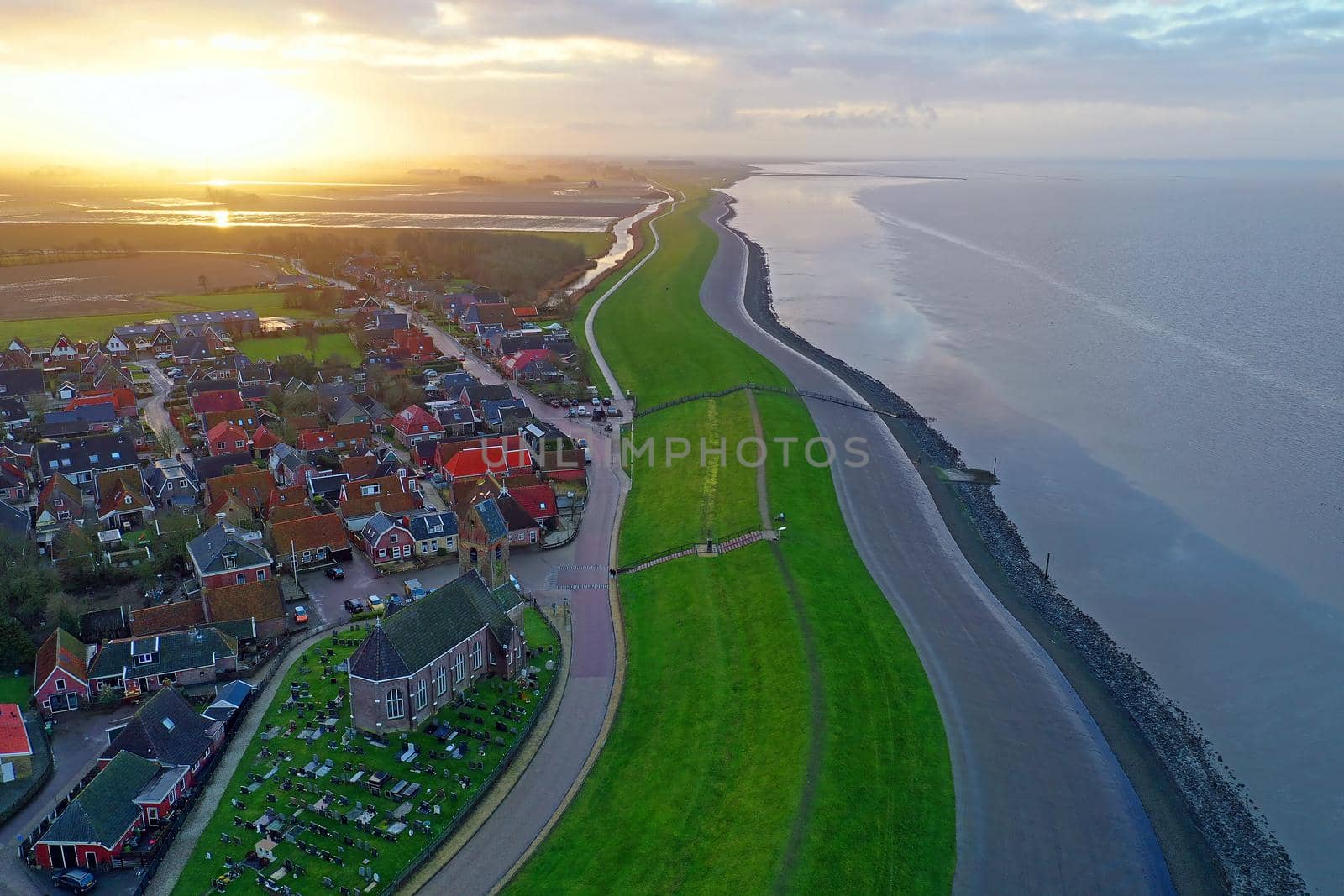 Aerial from the village Wierum in the Netherlands at sunset near the Waddenzee