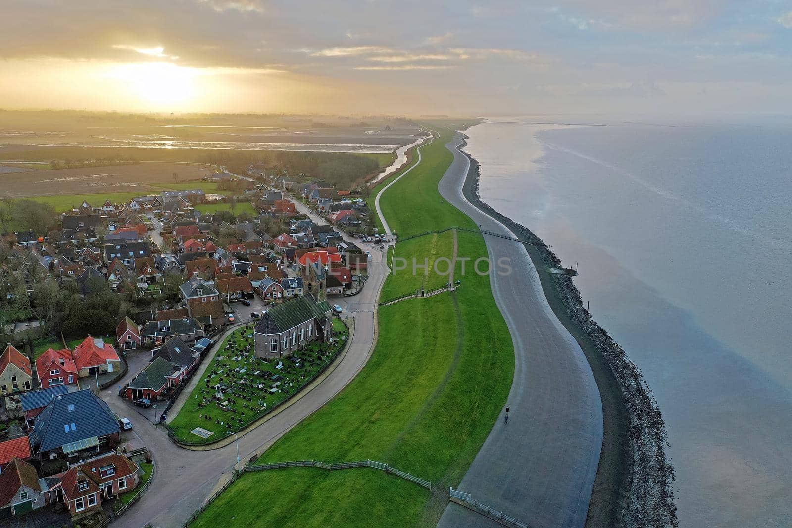 Aerial from the village Wierum in the Netherlands at sunset near the Waddenzee by devy