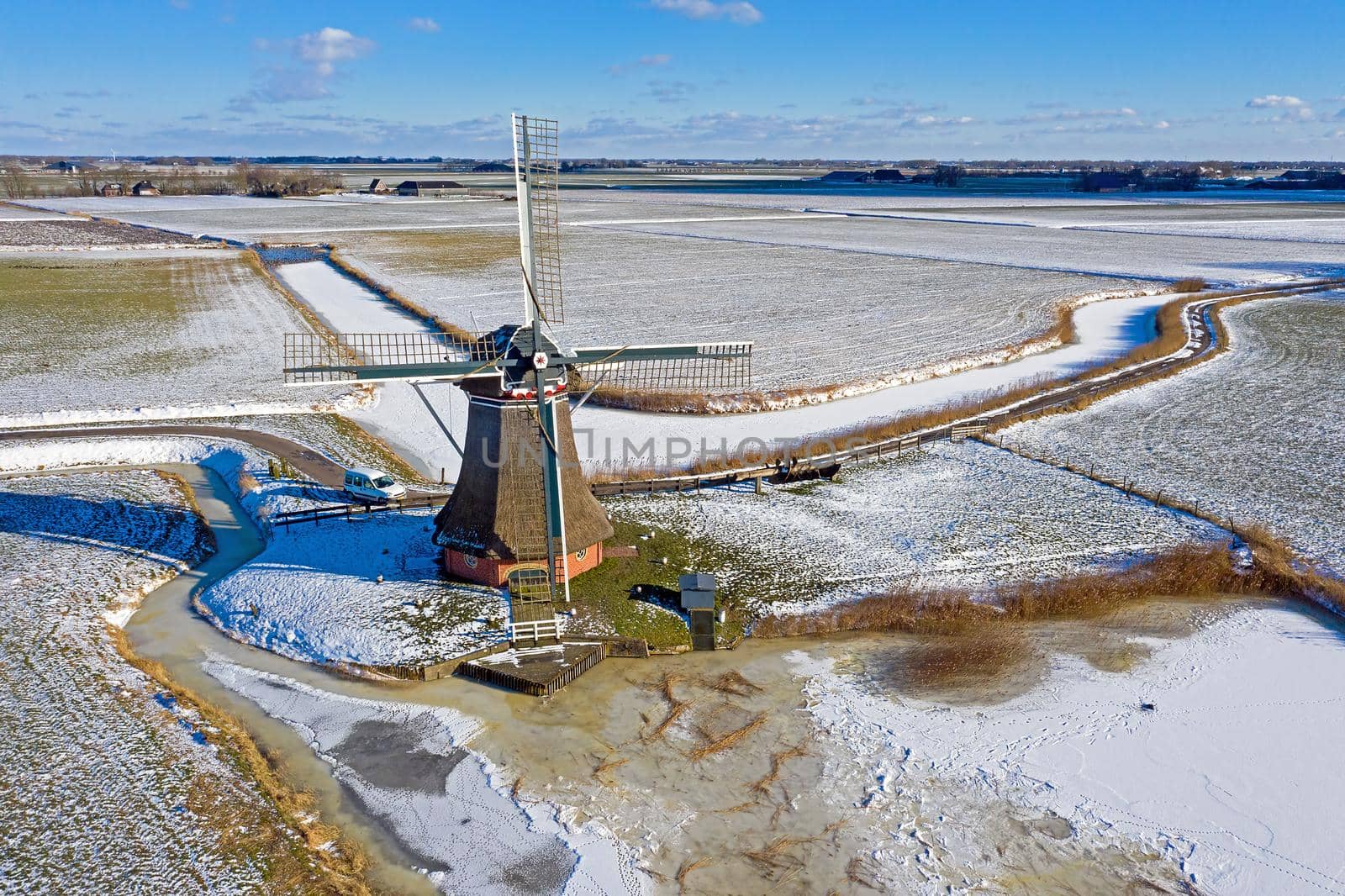 Aerial from a traditional windmill near Hantum in Friesland on a winter day in the Netherlands by devy