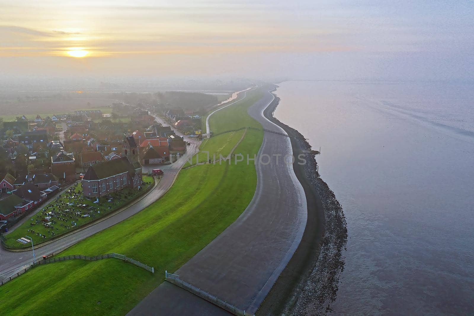 Aerial from the village Wierum in the Netherlands at sunset near the Waddenzee