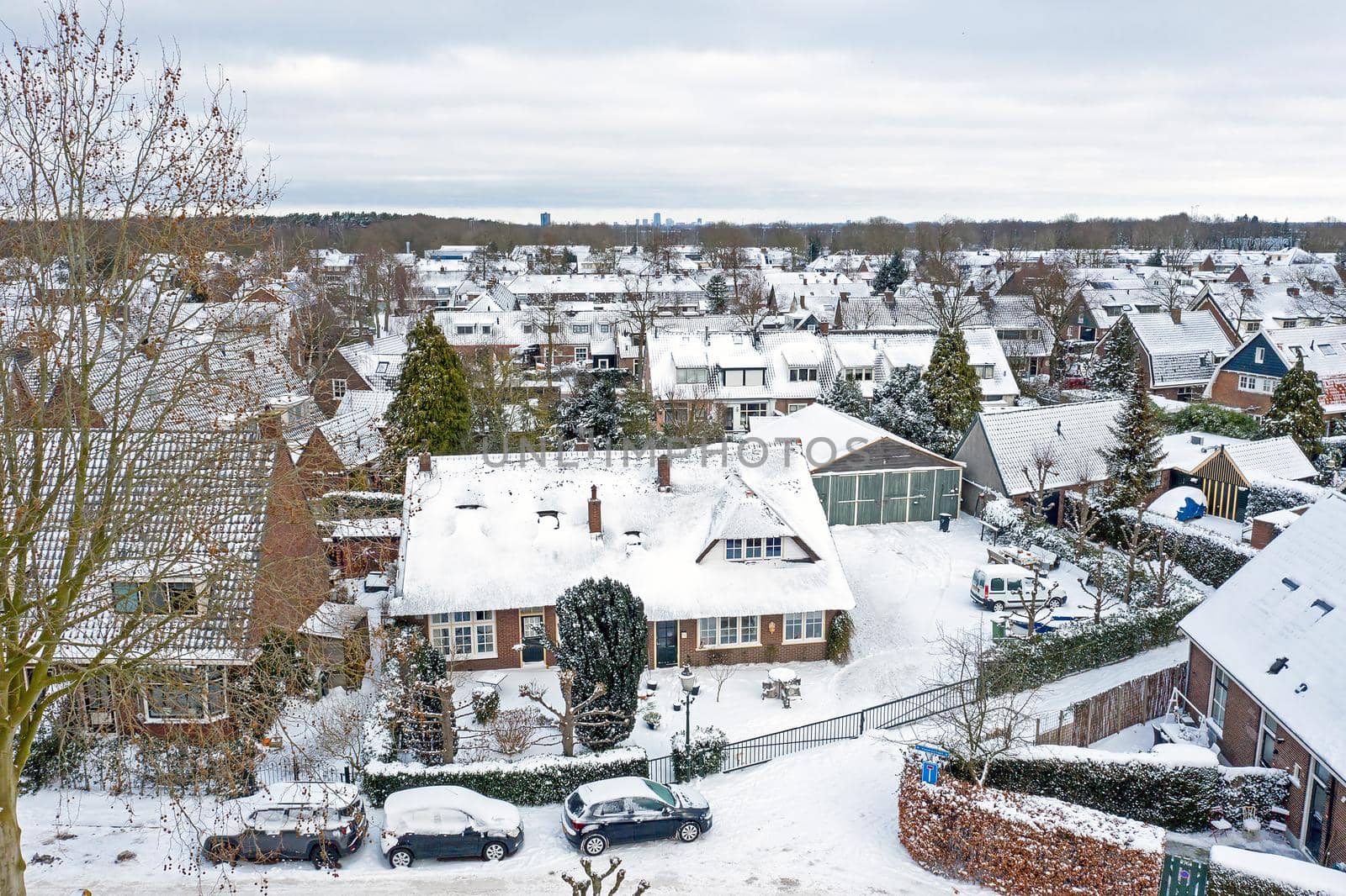 Aerial from snowy town Huizen in the Netherlands in winter by devy