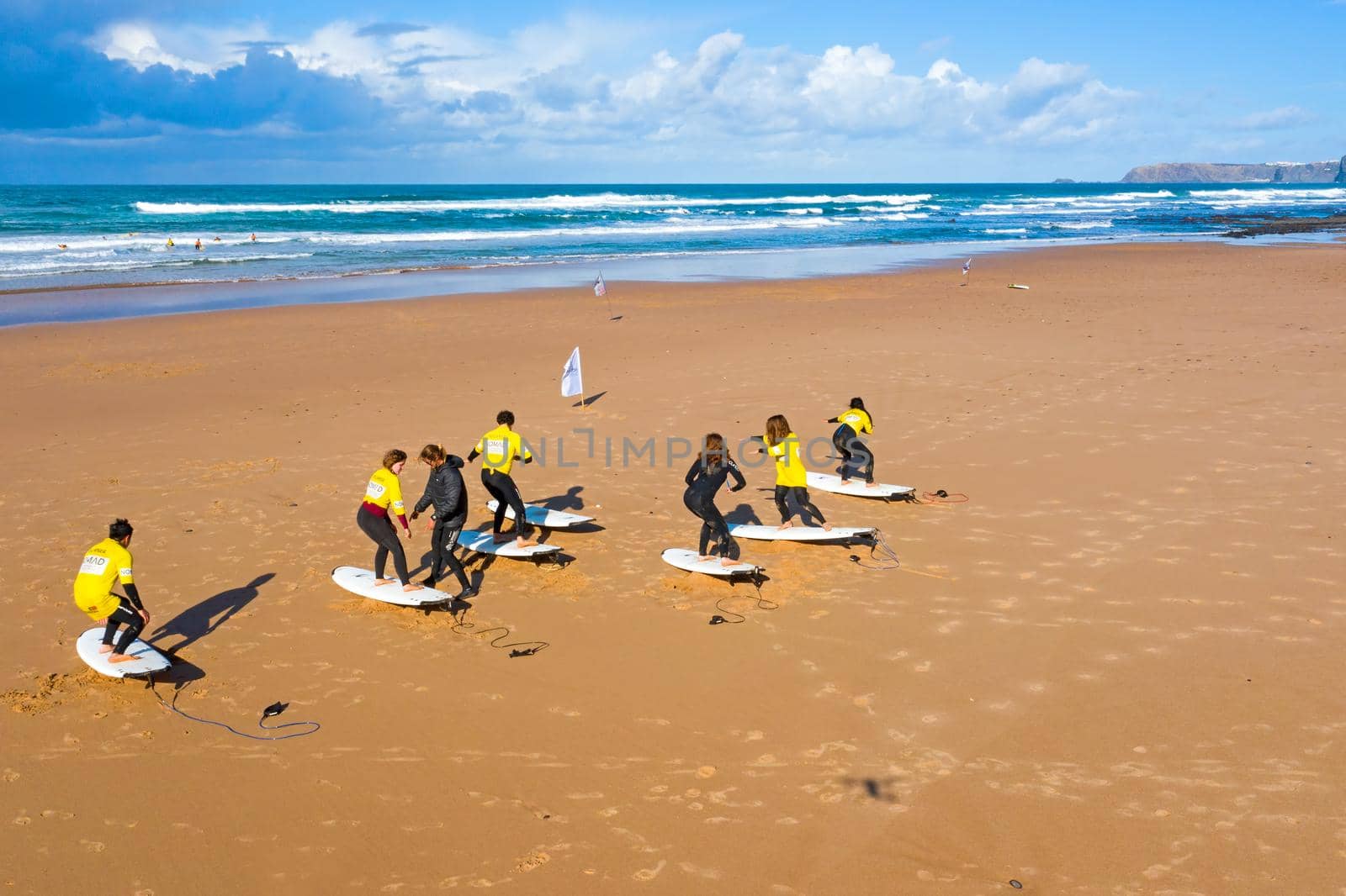 Vale Figueiras, Portugal - January 2, 2021: Surfers getting surflessons at Vale Figueiras beach in Portugal