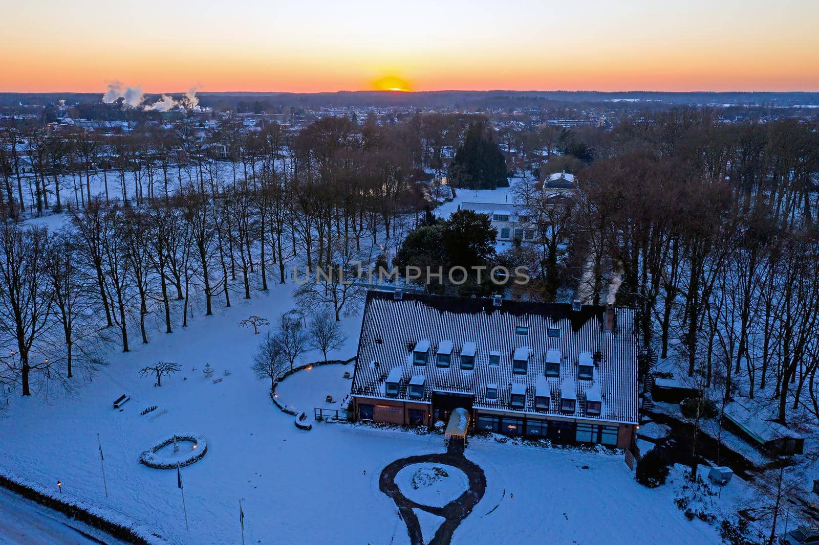 Aerial from a traditional dutch landscape in winter at sunset in the Netherlands by devy