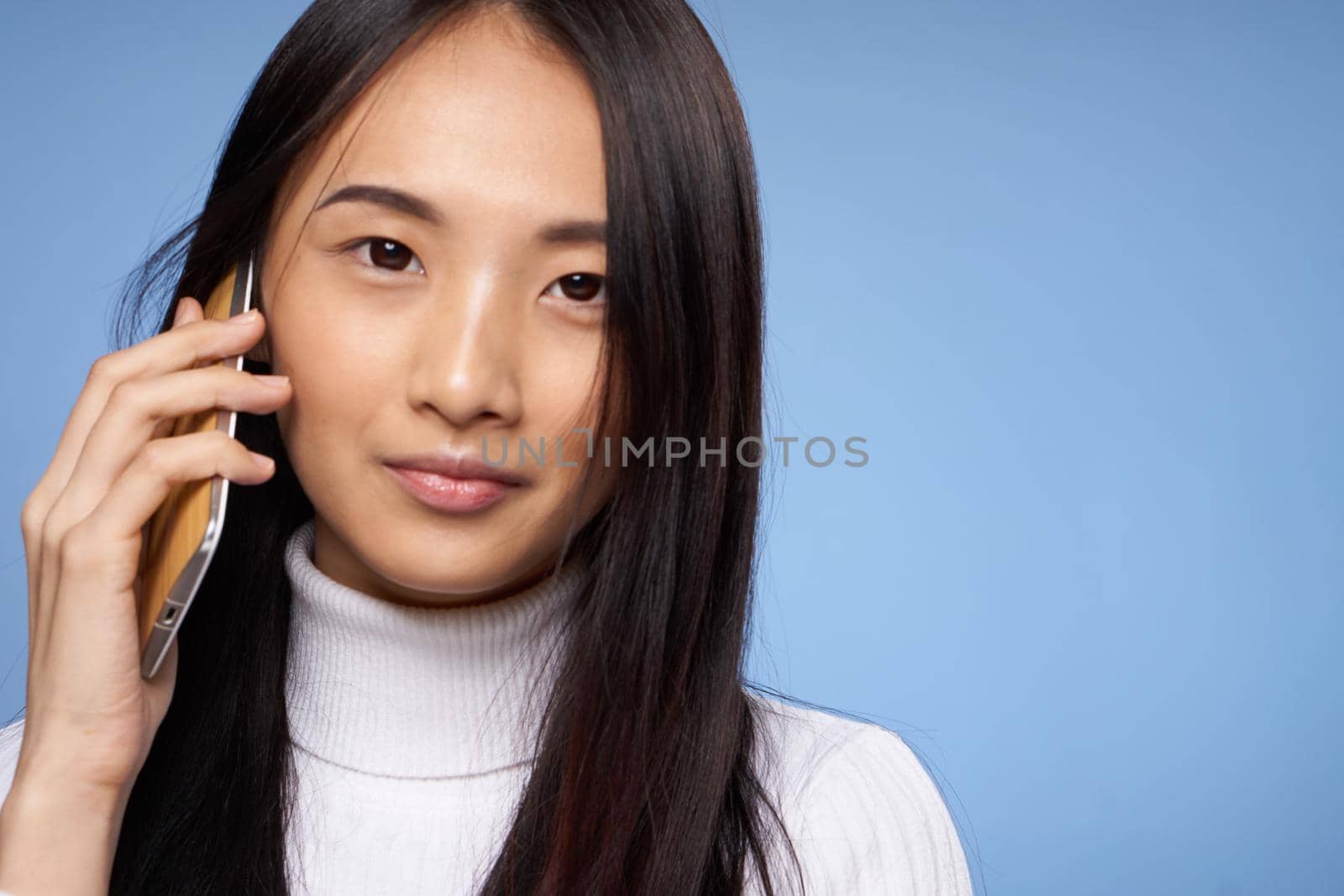 woman asian appearance phone communication technology lifestyle blue background by SHOTPRIME