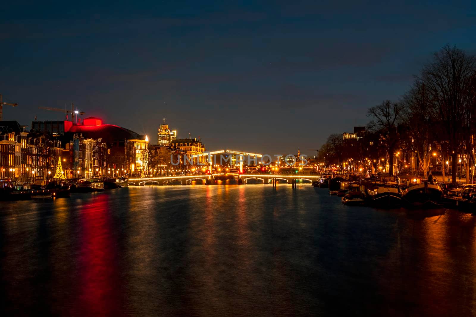 Tiny bridge in Amsterdam the Netherlands at sunset at the Amstel