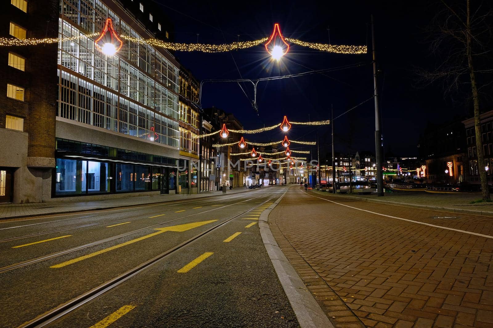 Christmas in Amsterdam at the Damrak at night in the Netherlands