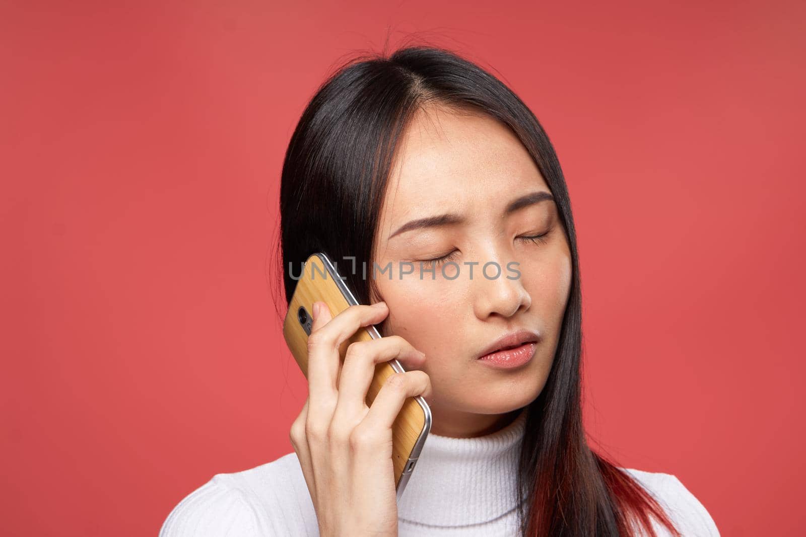 woman asian appearance talking on the phone lifestyle technology red background by SHOTPRIME