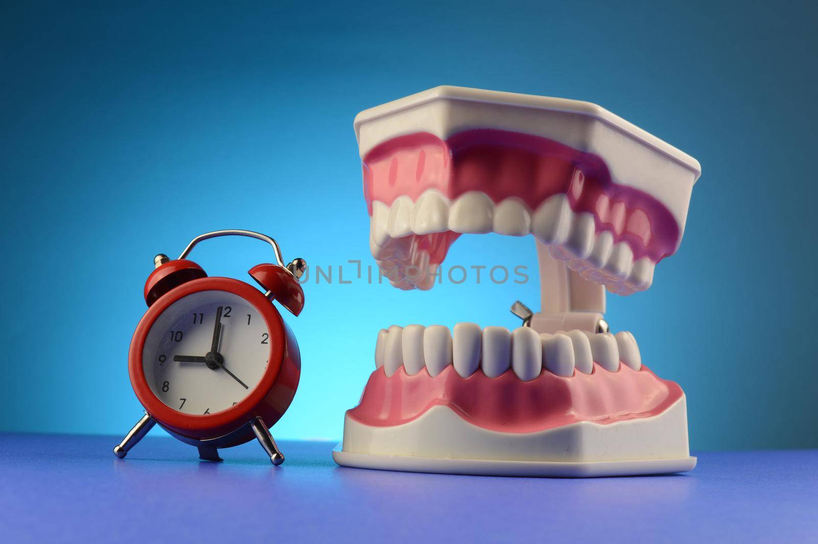 A clock and teeth display for dentist purposes.