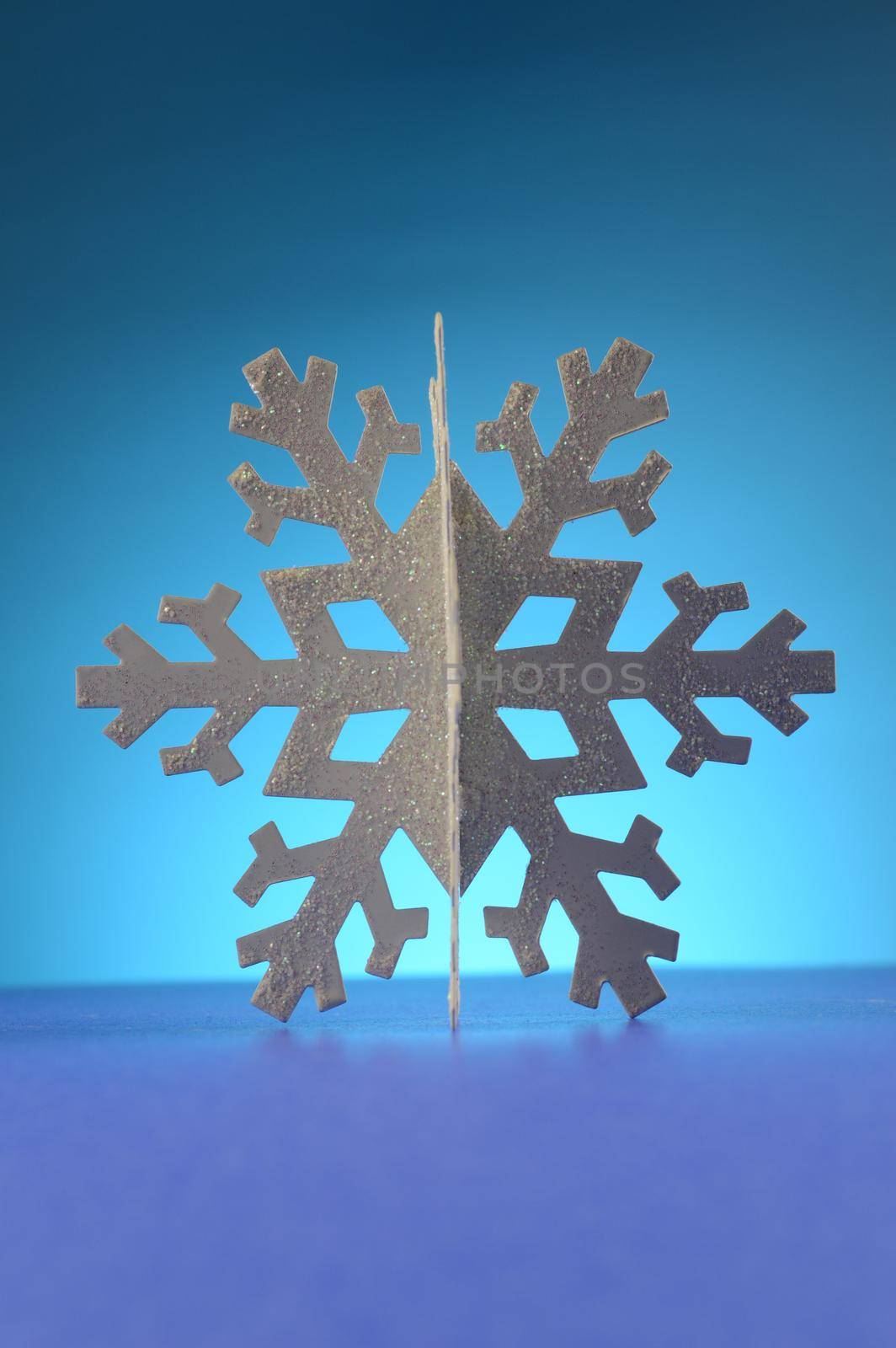 A cool winter snowflake over a blue background.