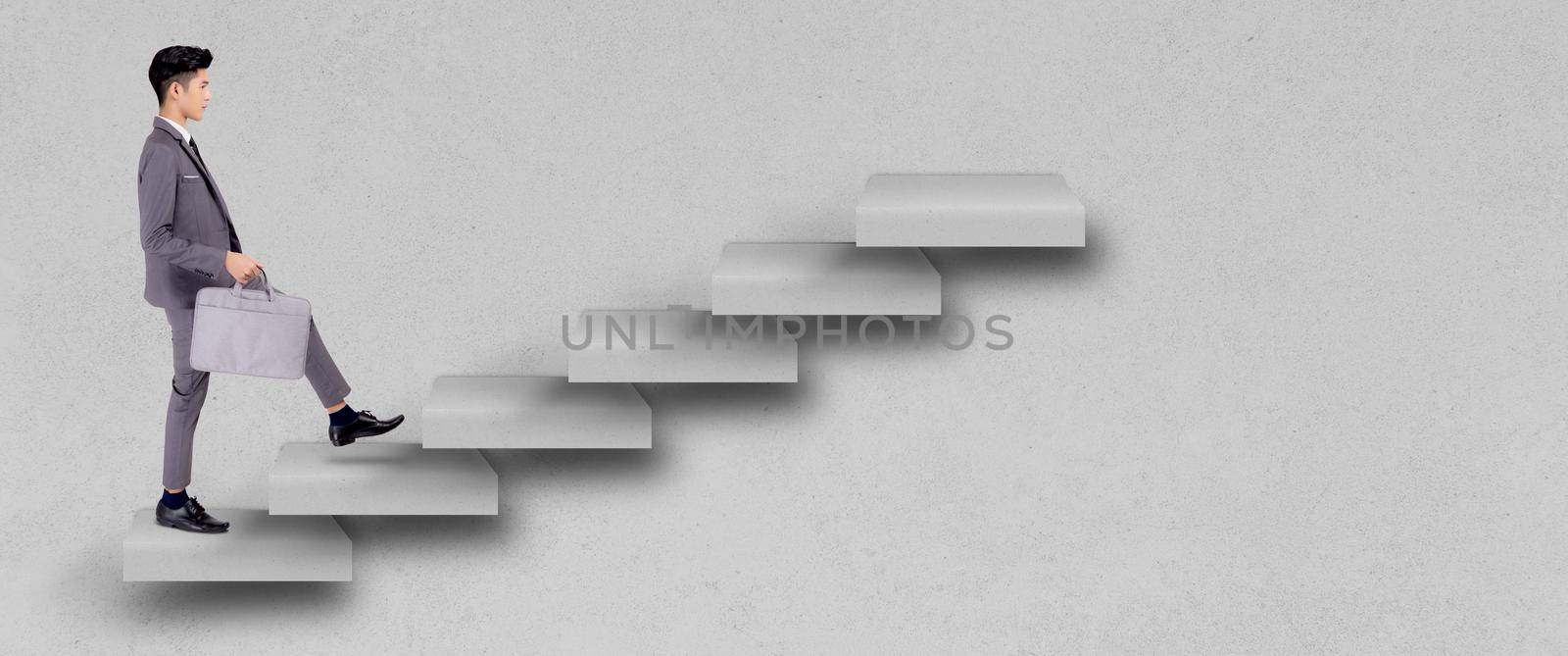 Businessman in suit walking up stair to achievement, man is leader climbing with aspiration for goal, inspiration and development for inspiration while progress go to winner, business concept.