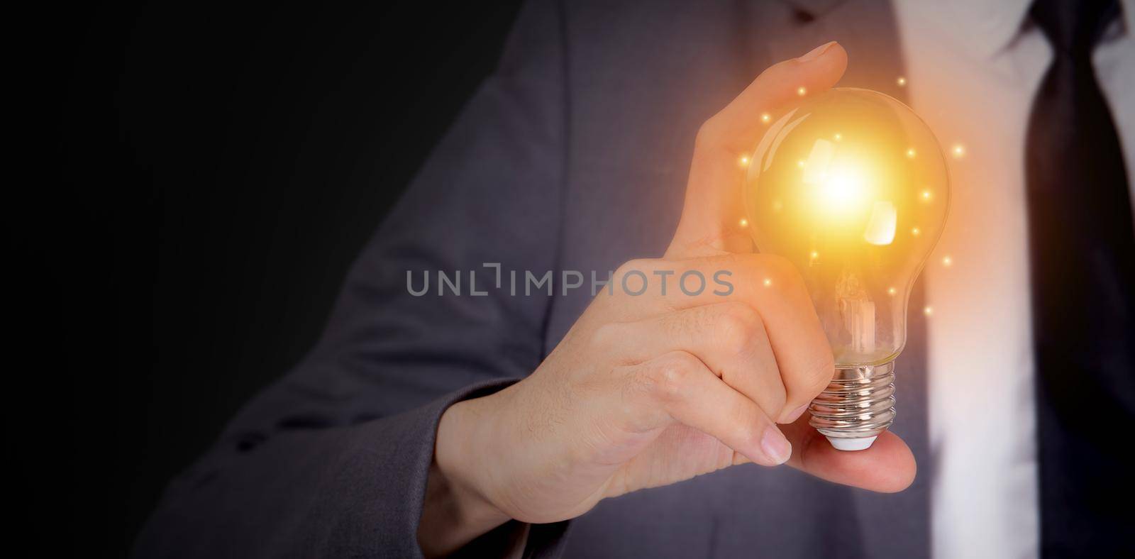 Businessman holding light bulb, imagination and intelligence, innovation and inspiration, brain symbol and solution and knowledge, creative idea and success, business and marketing concept.