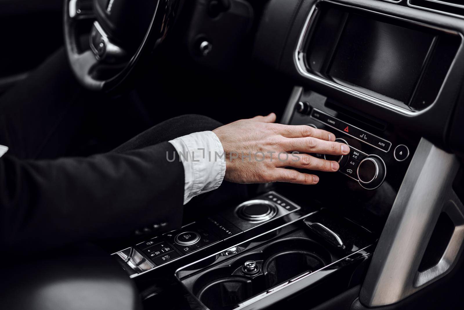 Close up of businessman using car system control. Transportation and vehicle concept