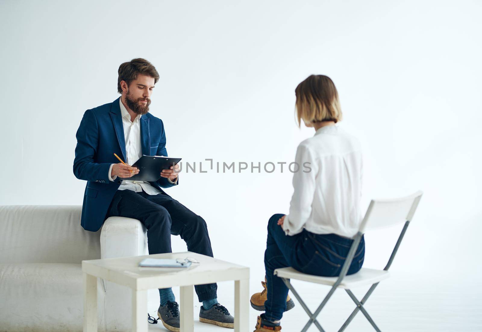 male doctor psychologist records consultation female patient. High quality photo