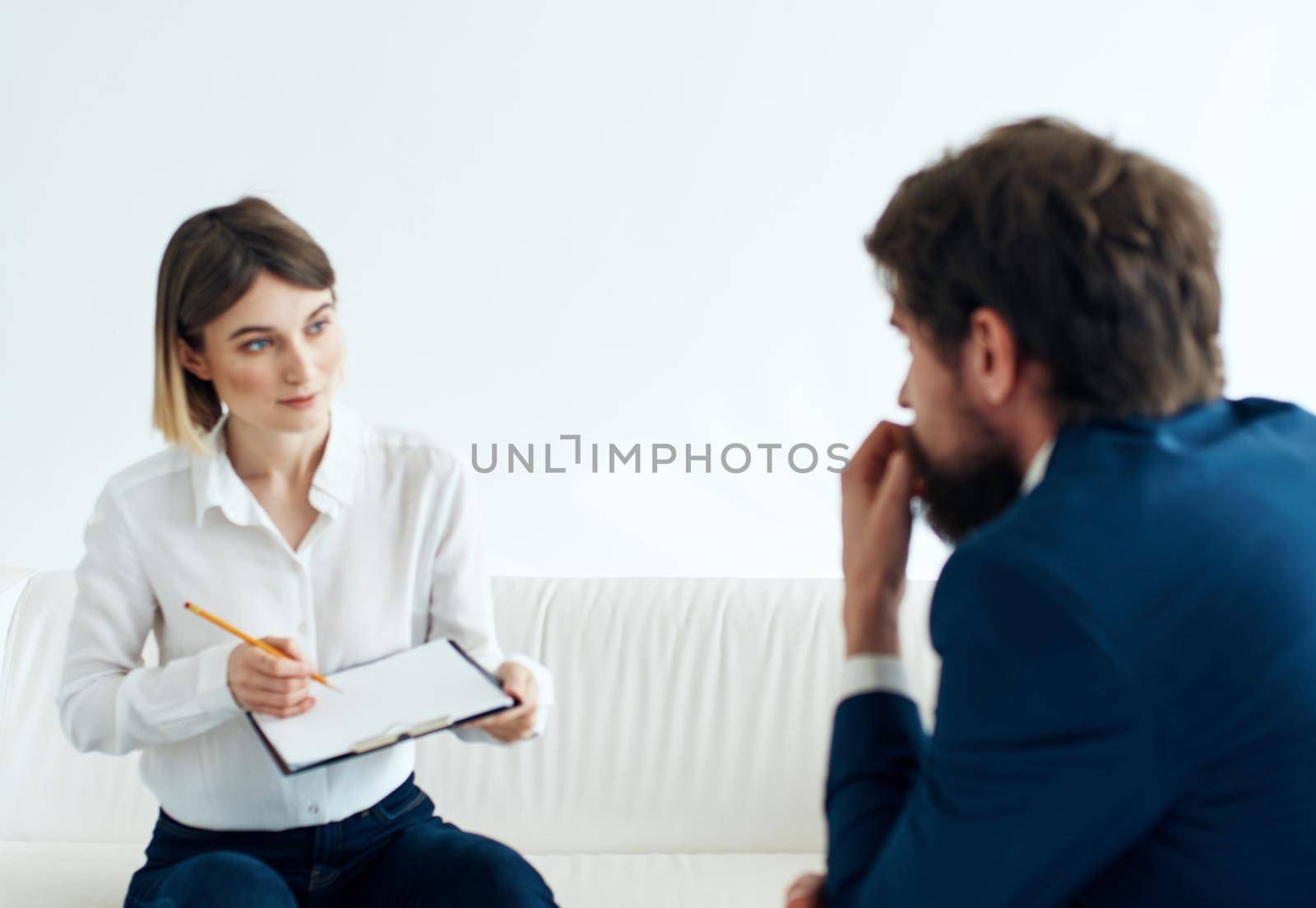 hiring vacancies woman with documents and a man in a suit are sitting on the couch. High quality photo