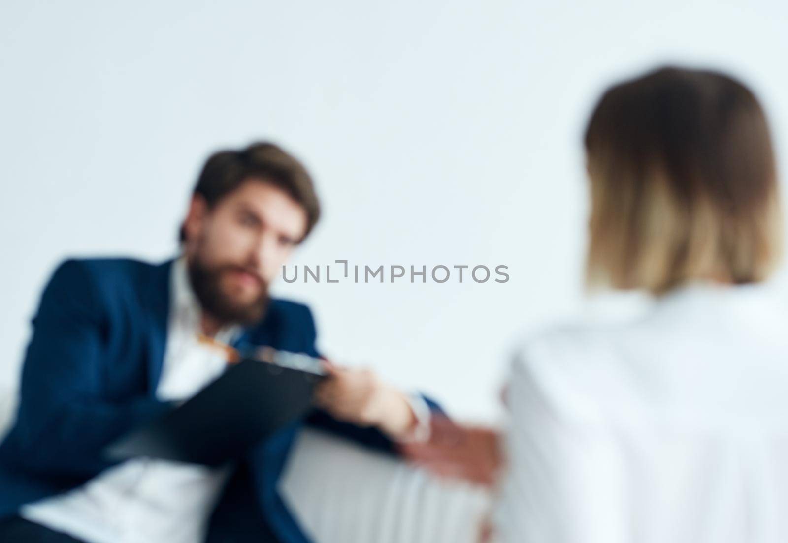 Man on the couch and woman business finance staff communication by SHOTPRIME