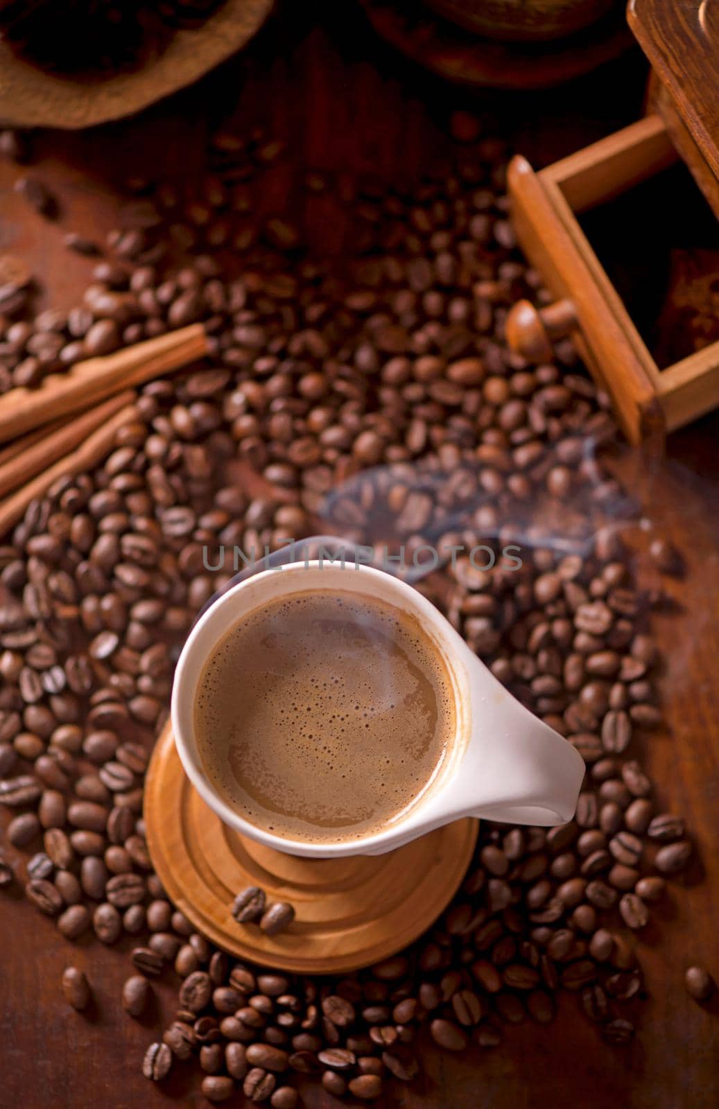 cup of coffee and coffee beans in a sack on dark background, top view by aprilphoto