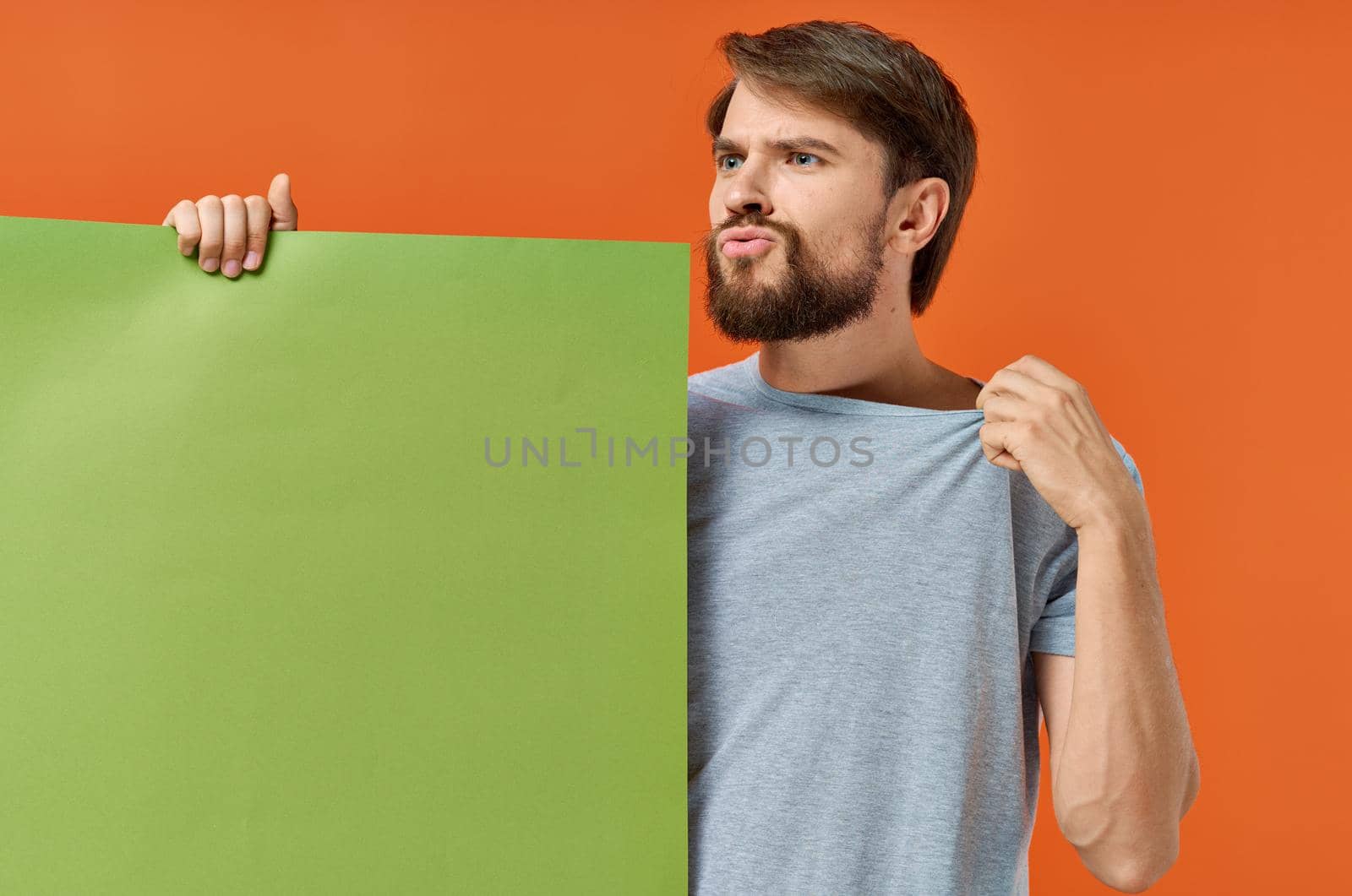 bearded man holding and green banner communication marketing isolated background. High quality photo