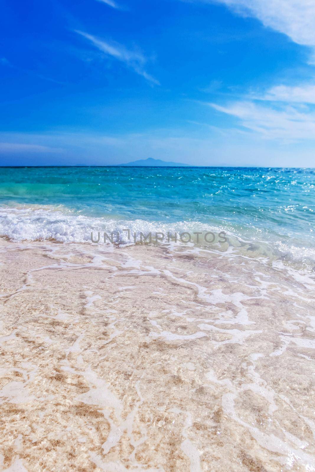 Beach and beautiful tropical sea under clear blue sky