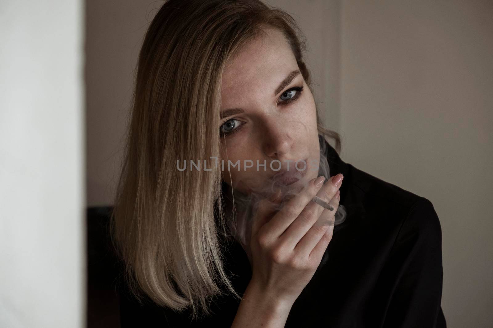 Close-Up Of Young Woman Smoking Cigarette By Window