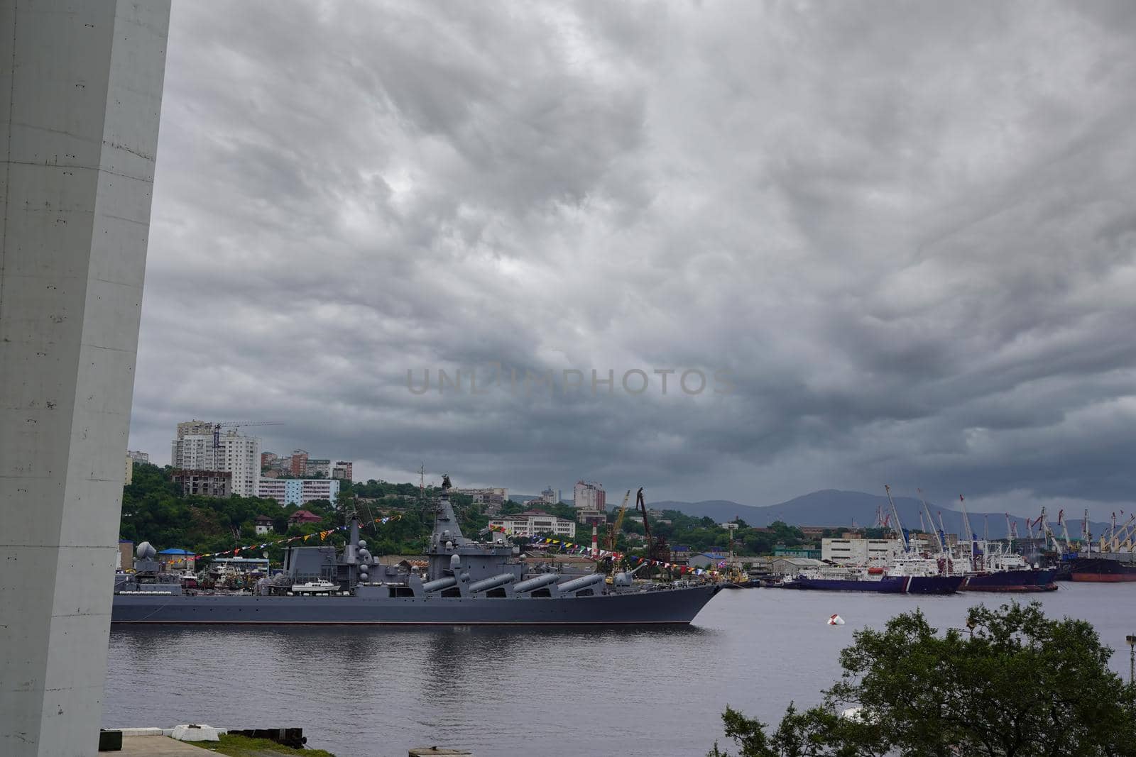 City landscape with a view of a warship under the Golden bridge. Vladivostok, Russia