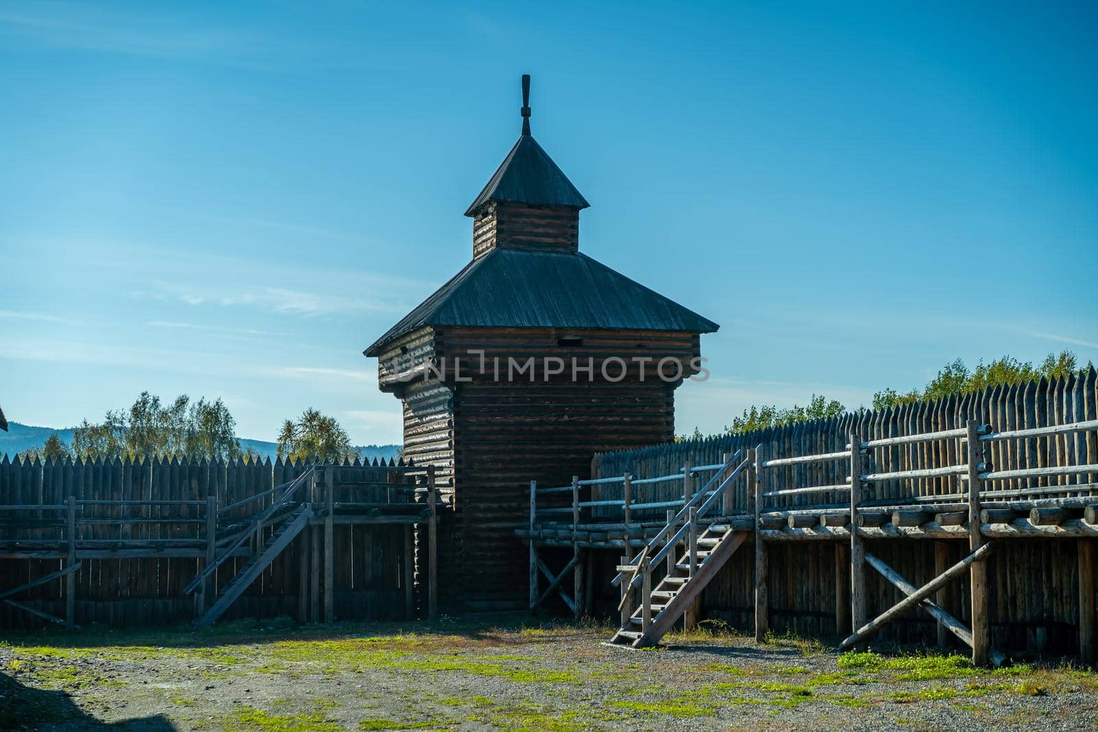 Natural landscape with wooden buildings. Irkutsk region, Taltsy