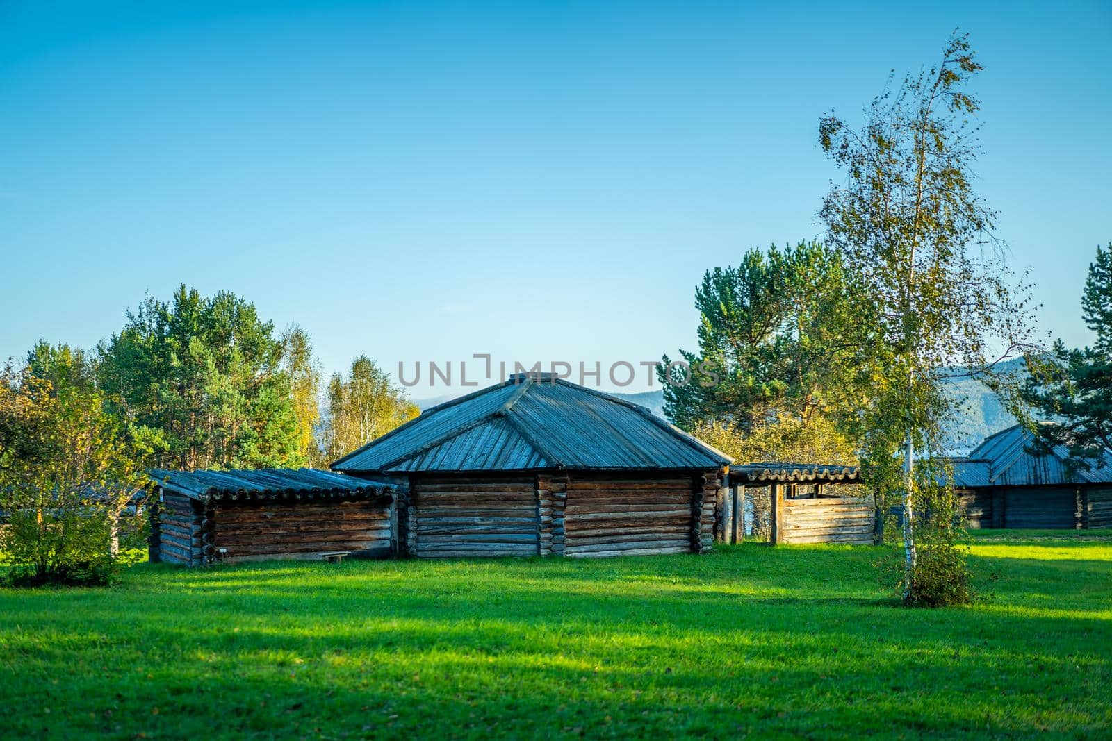 Natural landscape with wooden buildings. Irkutsk region, Taltsy