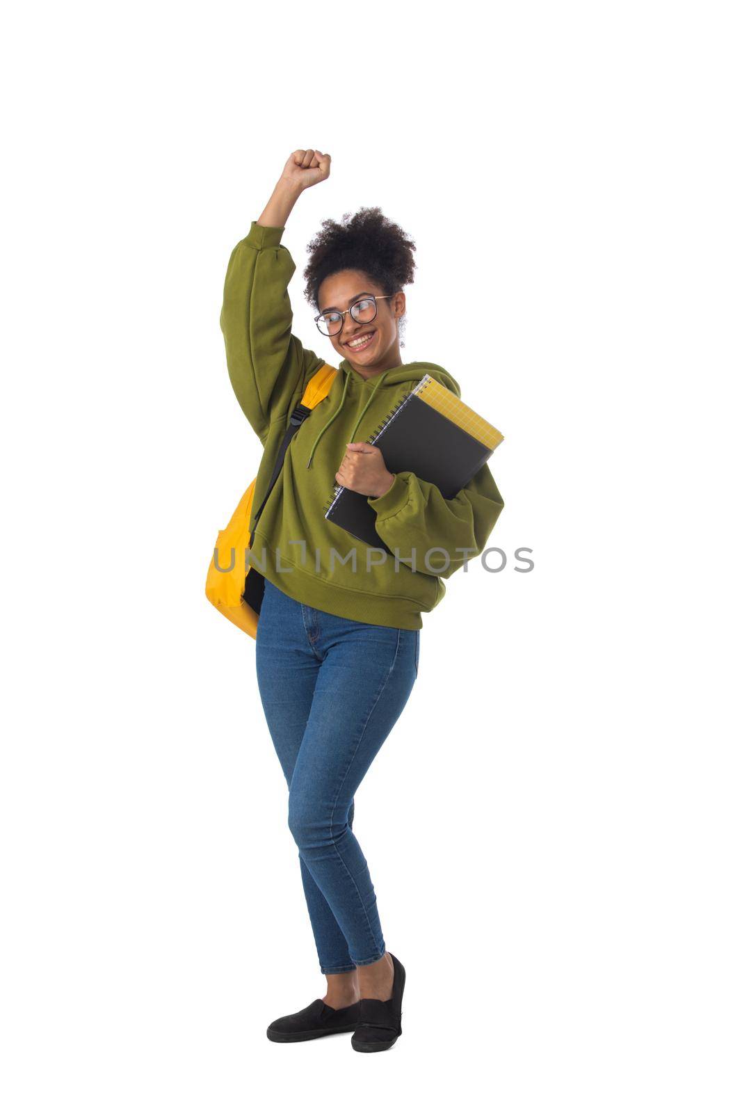 Friendly ethnic black female high school student in eyeglasses with backpack and composition book isolated on white background, full length portrait