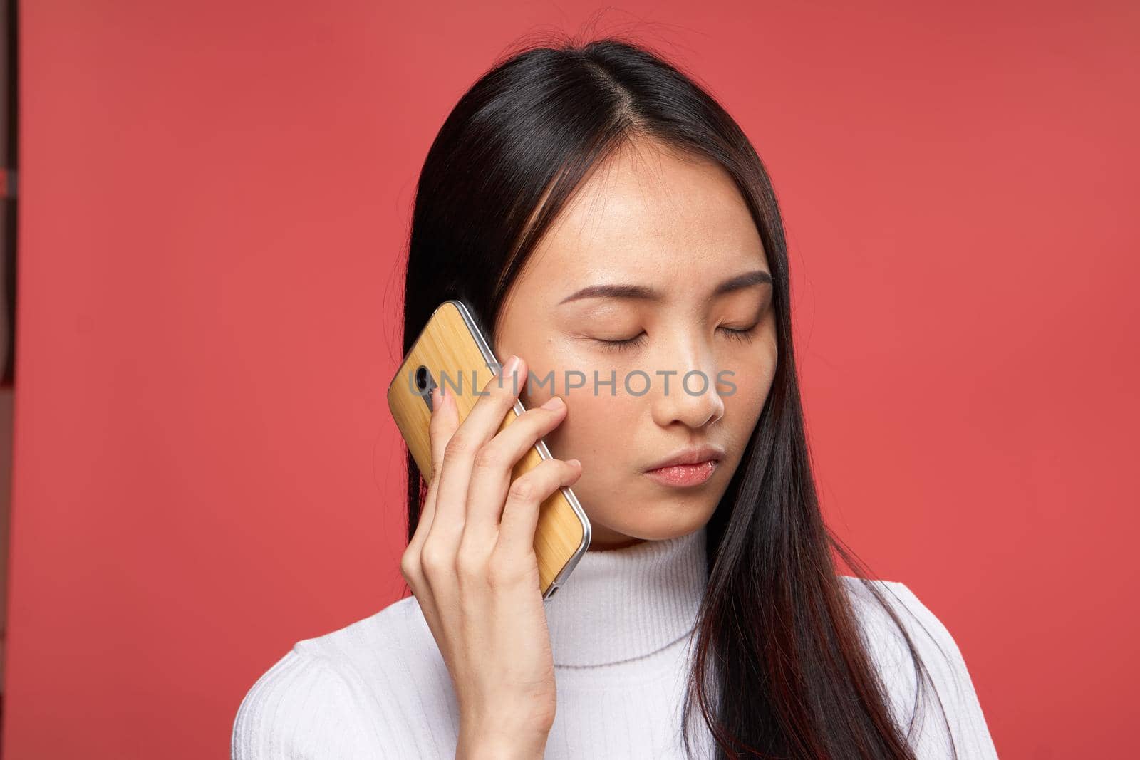 woman asian appearance talking on the phone lifestyle technology red background by SHOTPRIME