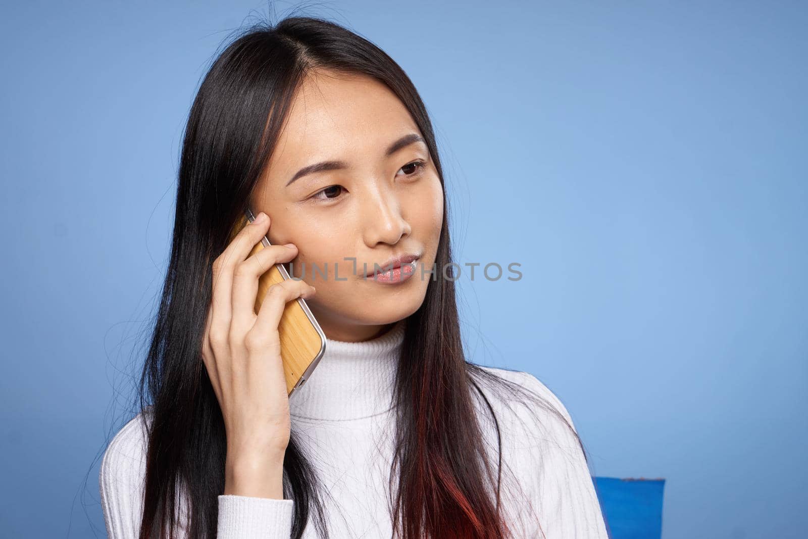 pretty brunette talking on the phone white sweater studio close-up by SHOTPRIME