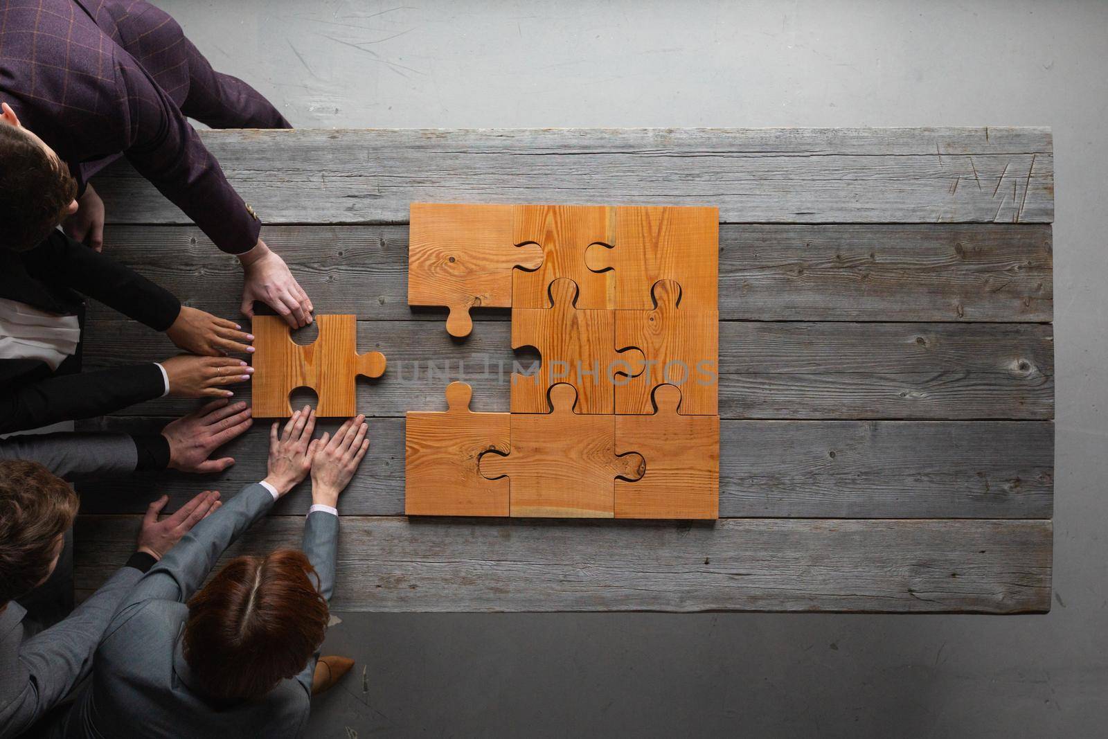 Business teamwork with puzzle by ALotOfPeople