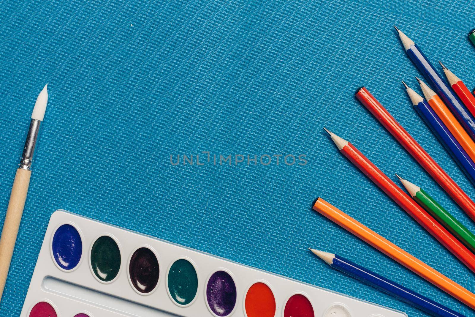 colored pencils watercolor paint art drawing art school blue background. High quality photo