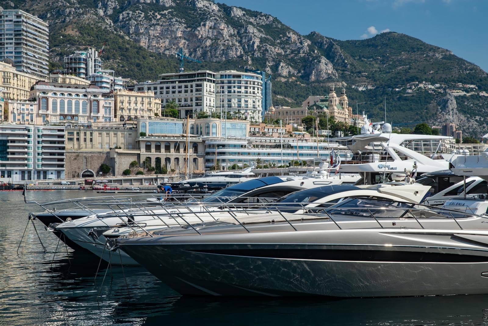 Monaco, Monte-Carlo, 06 August 2018: Tranquillity in port Hercules, is the parked boats, sunny day, many yachts and boats, a lot of Rivas boats, megayachts, massif of expensive real estate by vladimirdrozdin