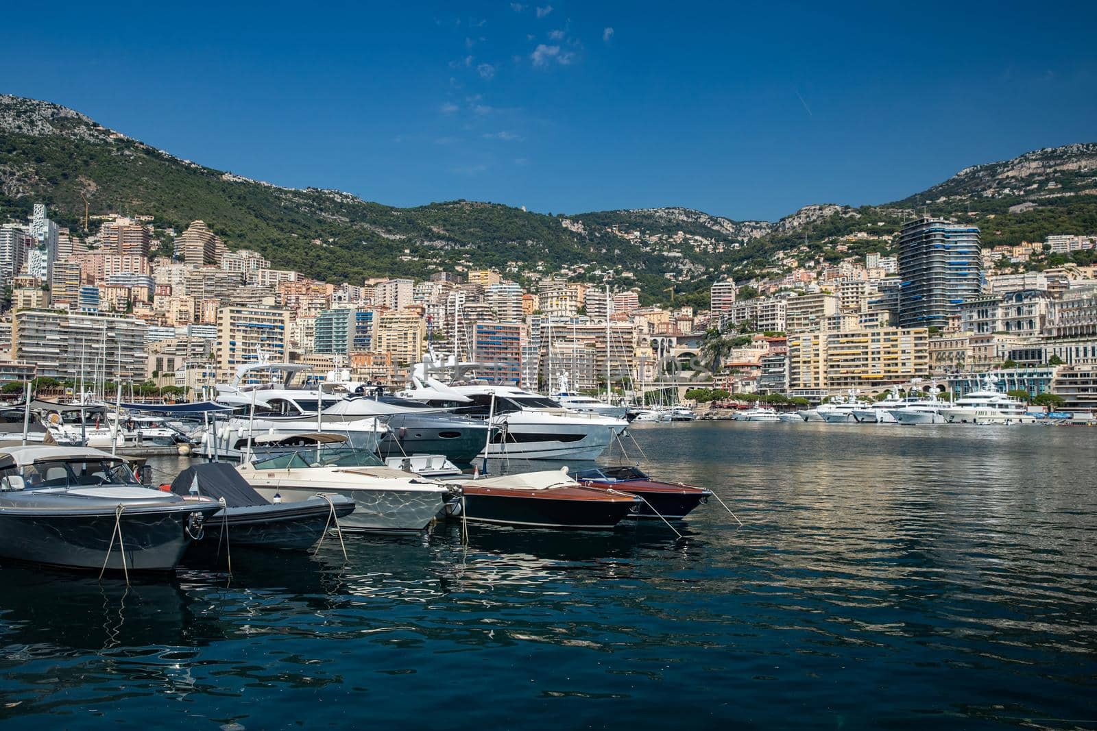 Monaco, Monte-Carlo, 06 August 2018: Tranquillity in port Hercules, is the parked boats, many yachts and boats, RIVA, Prince's Palace of Monaco, megayachts, massif of expensive real estate