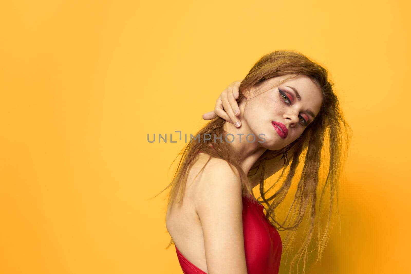 Pretty woman wavy hair red tank top fashion lifestyle cosmetics yellow background by SHOTPRIME