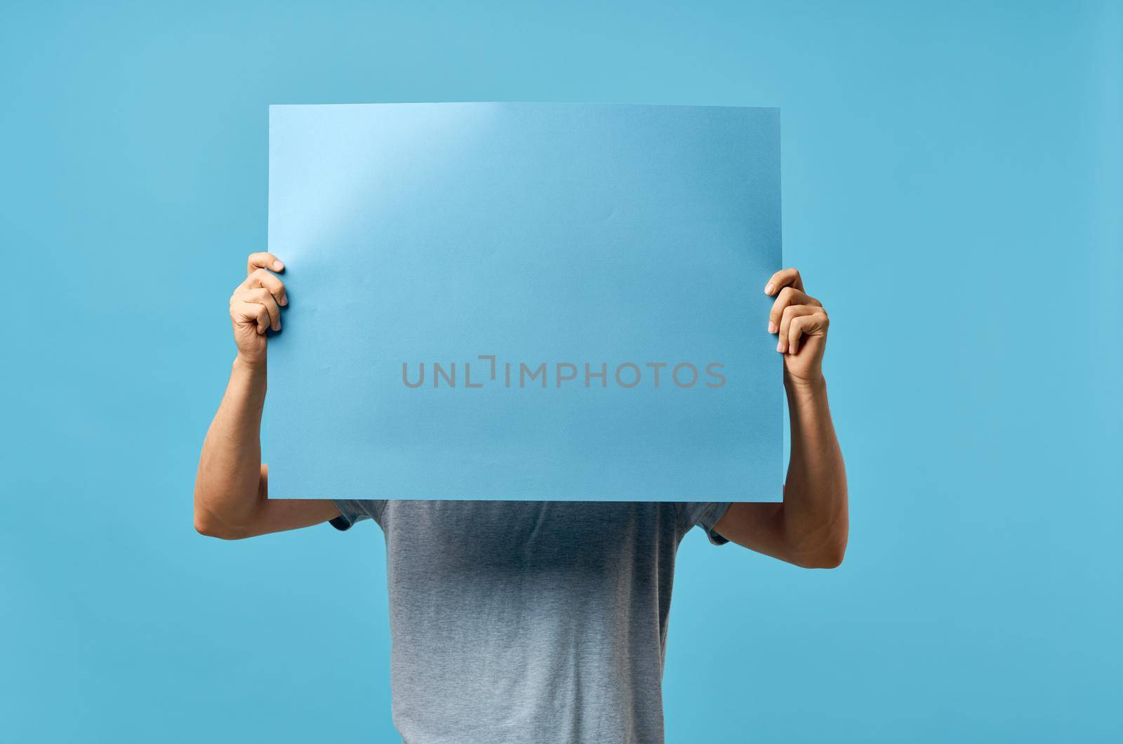 blue mockup poster men hands cropped view advertisement. High quality photo