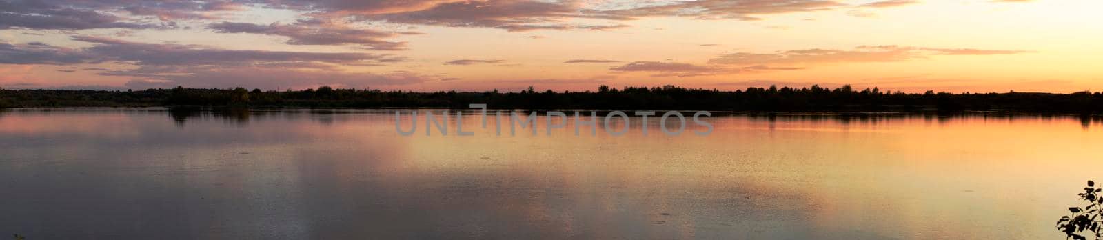 A colorful sunny sunset is reflected on the surface of the calm lake. by AnatoliiFoto