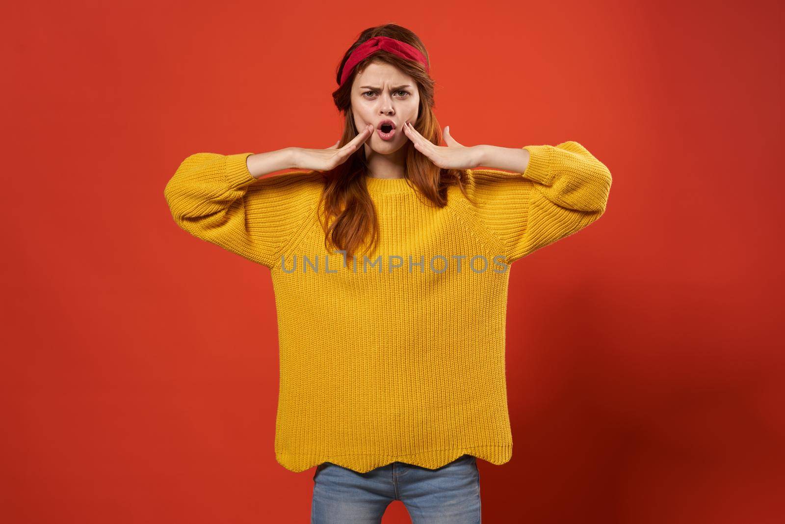 cheerful red-haired woman in yellow sweater emotions streetwear fashion red background by SHOTPRIME