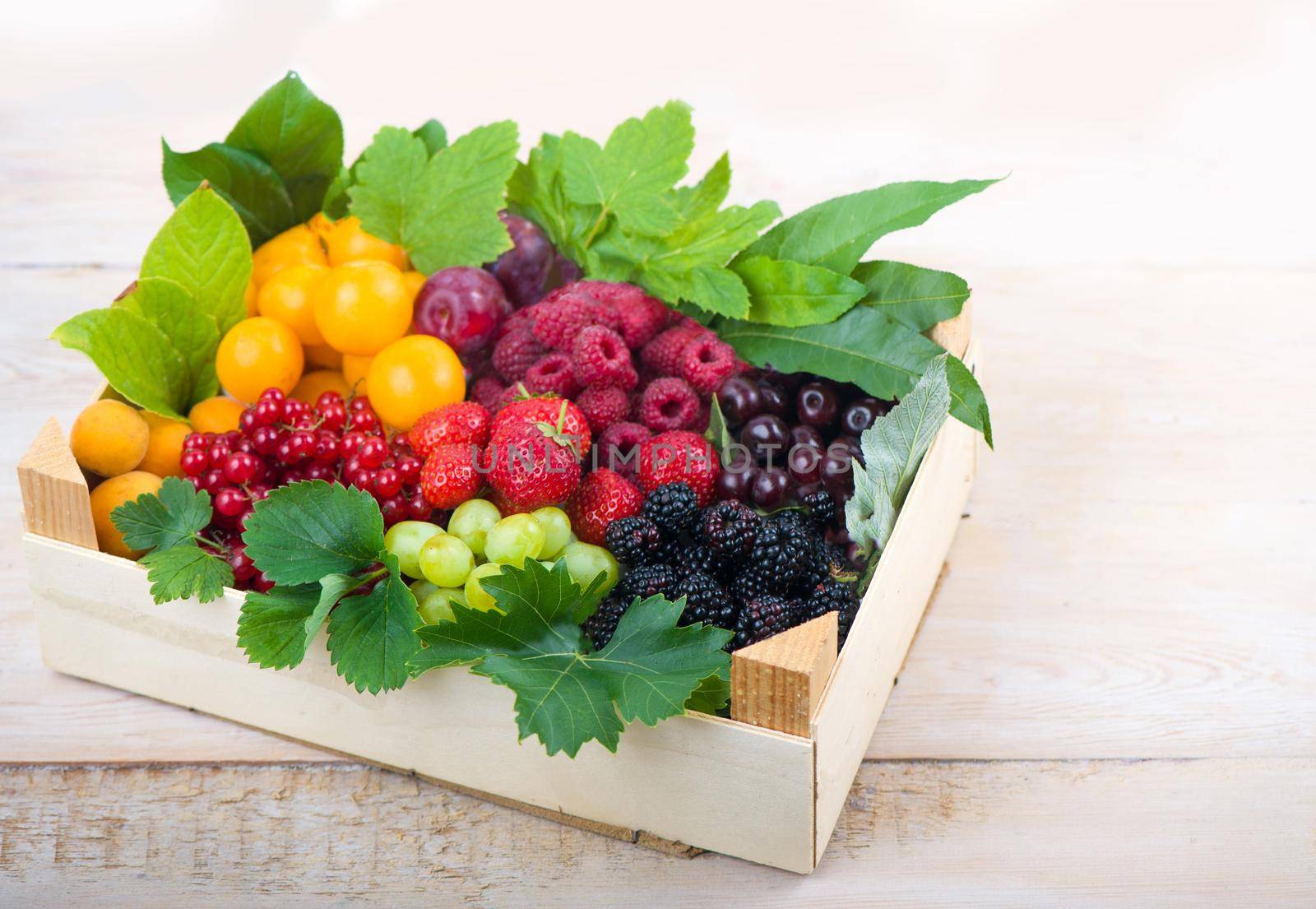 berry mix isolated in the box on a white background by aprilphoto