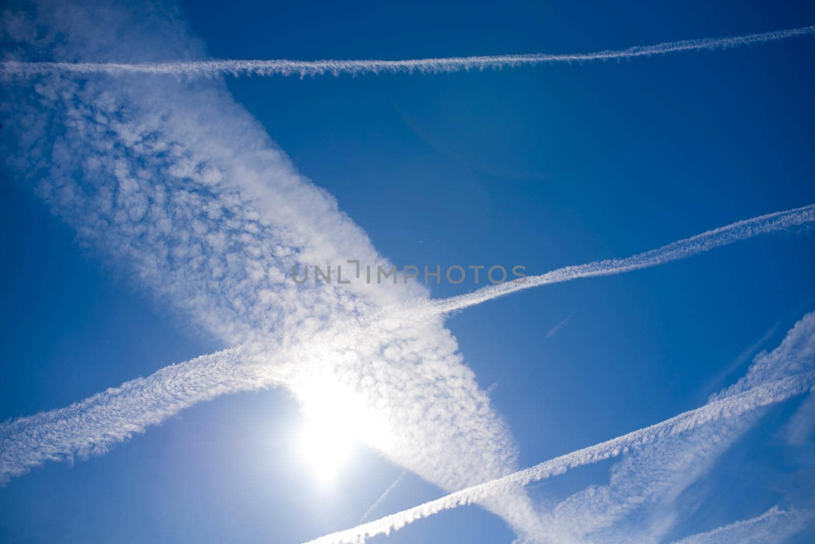 blue sky with many clouds lines made of aircraft by aprilphoto