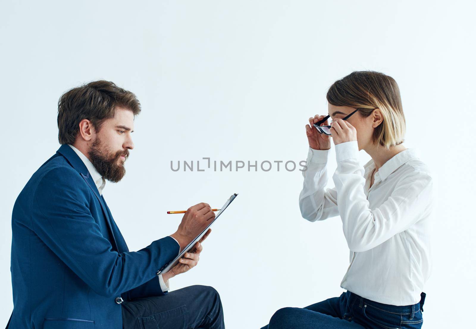 Emotional woman and young man communication on a light background psychology understanding. High quality photo