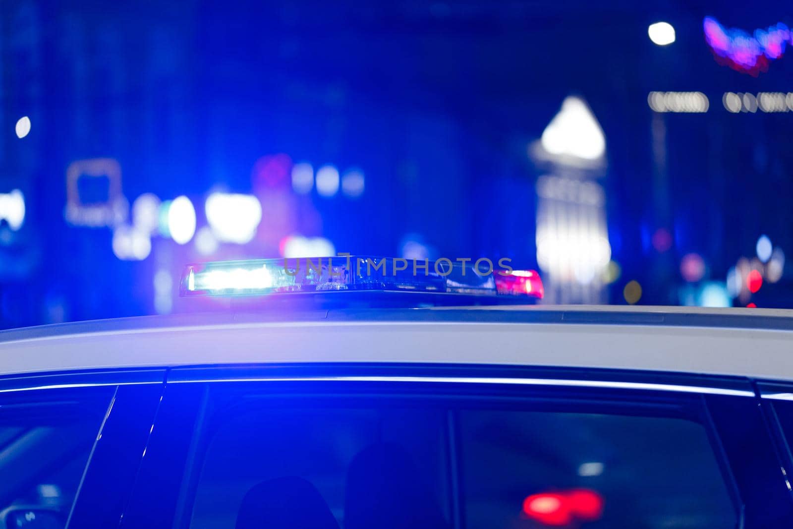 police car lights at night in city with selective focus and bokeh blur