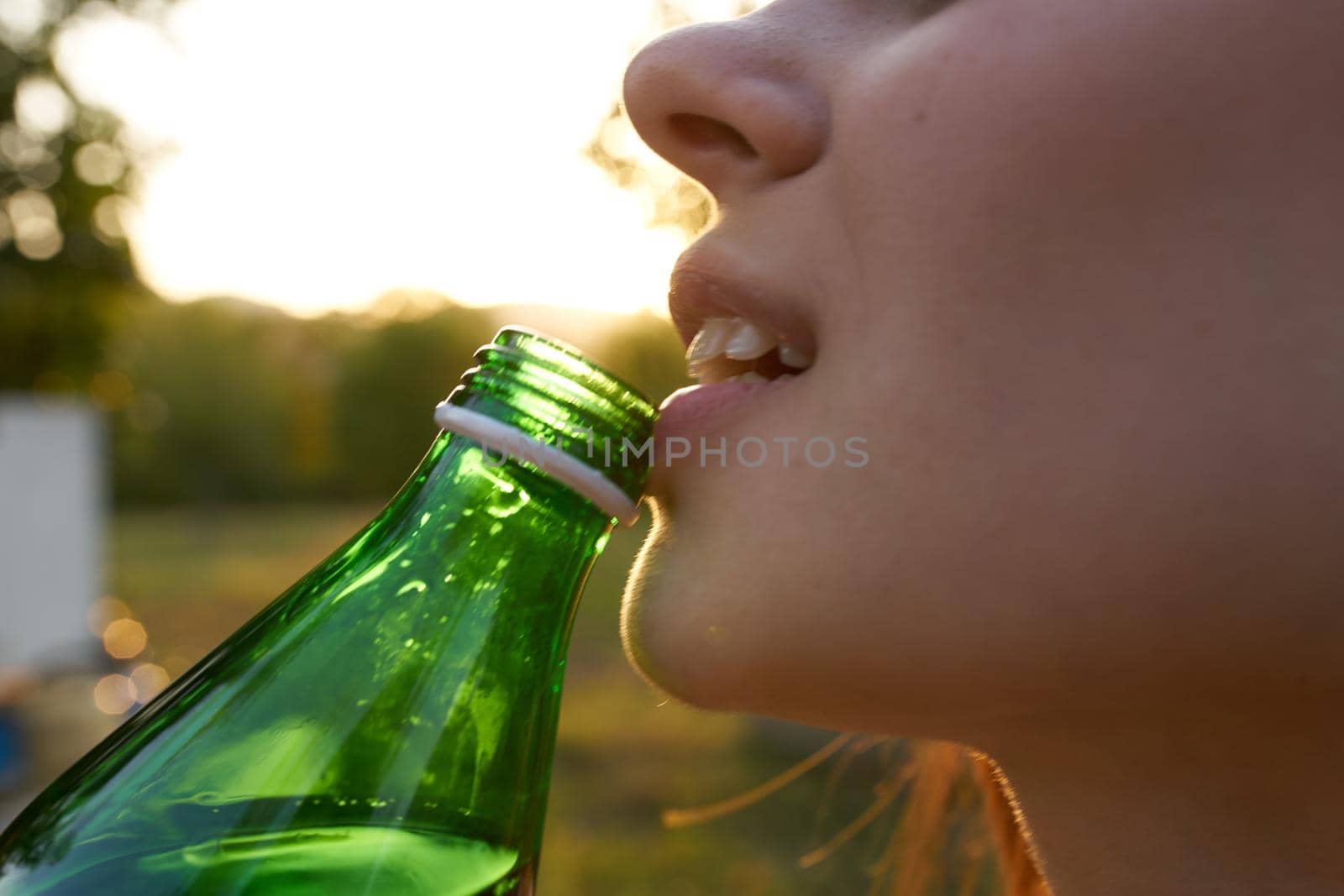 happy woman with bottle of water for invitation in garden close-up cropped view by SHOTPRIME