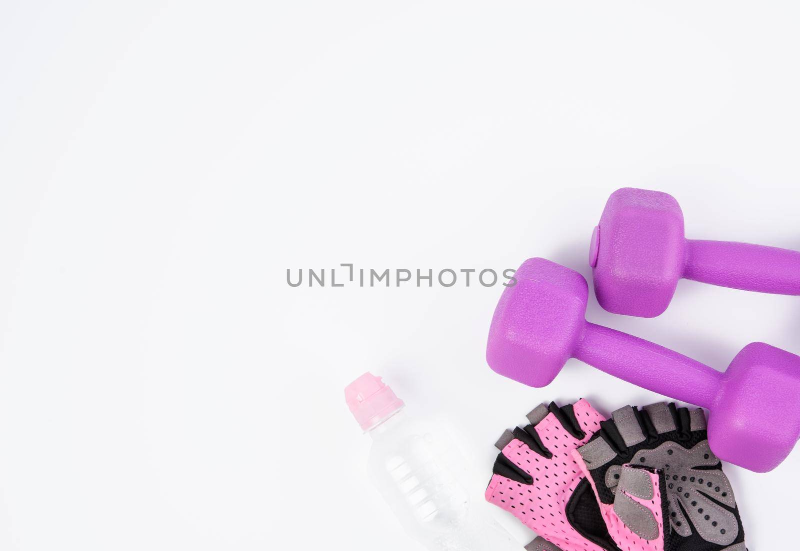 pink sports gloves, pair of purple dumbbells and and bottle of water on a white background, healthy lifestyle