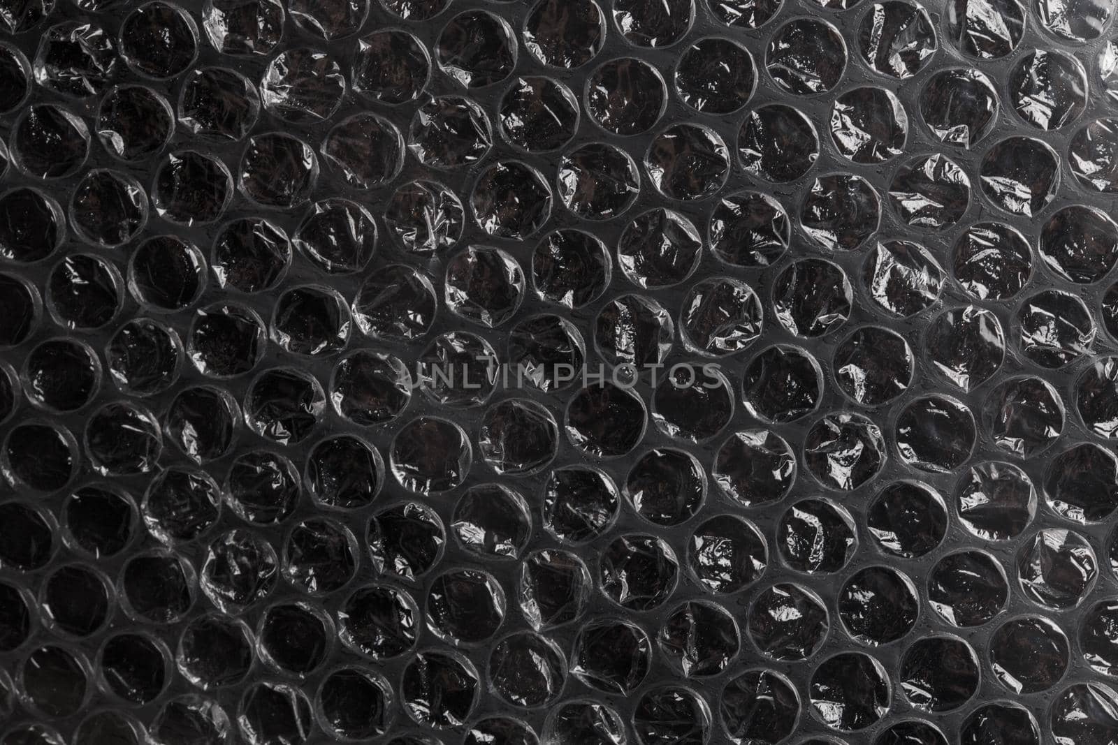 dark air bubble wrap - real life close-up texture and background by z1b