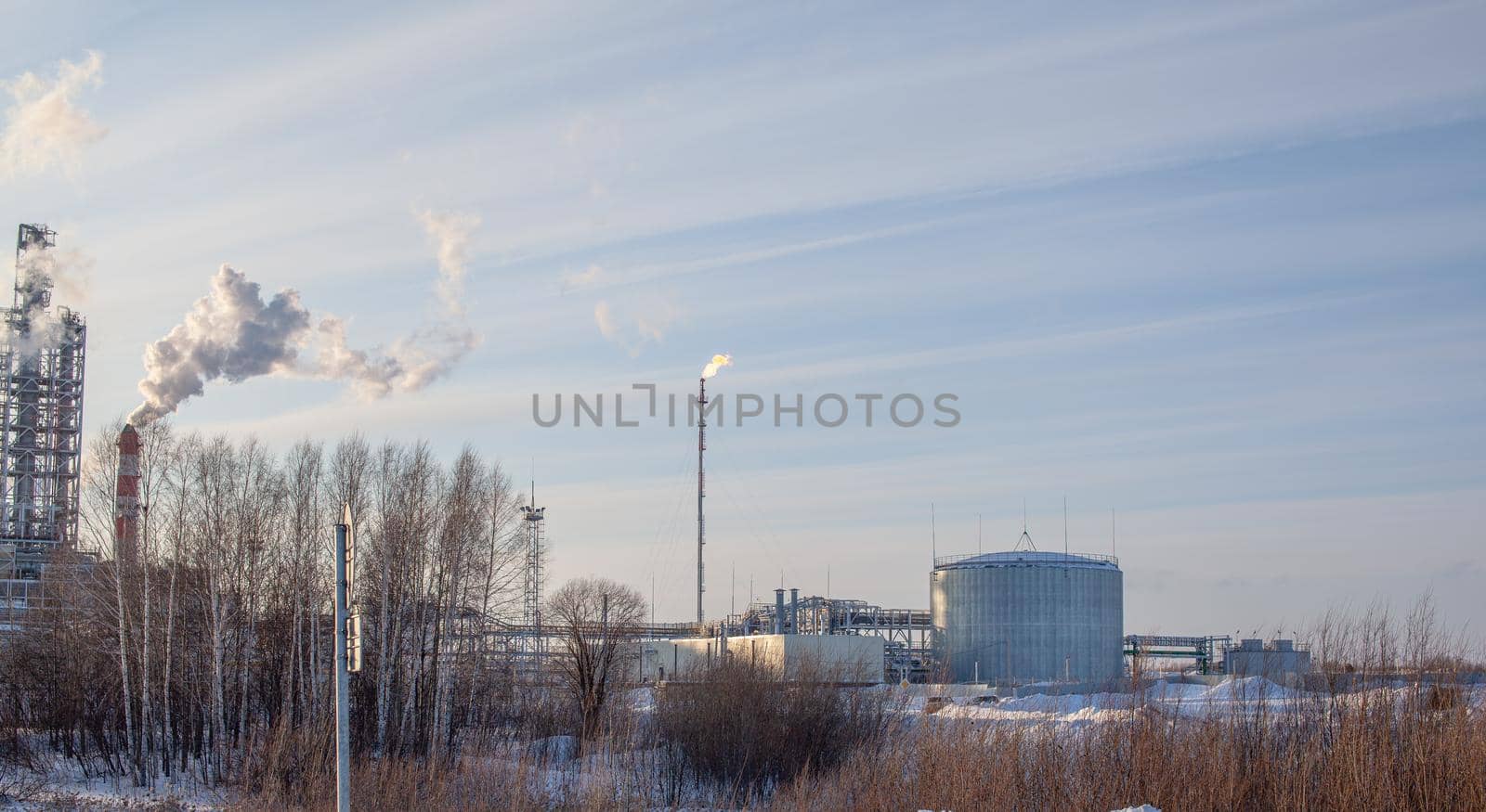 Petrochemical industrial factory of heavy industry, power refinery production with smoke pollution. Thick smoke is coming from the factory's chimney