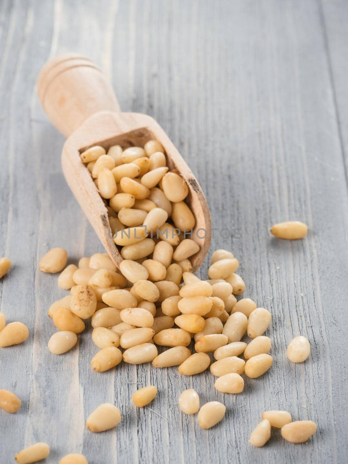 Pine nuts on gray wooden background by fascinadora