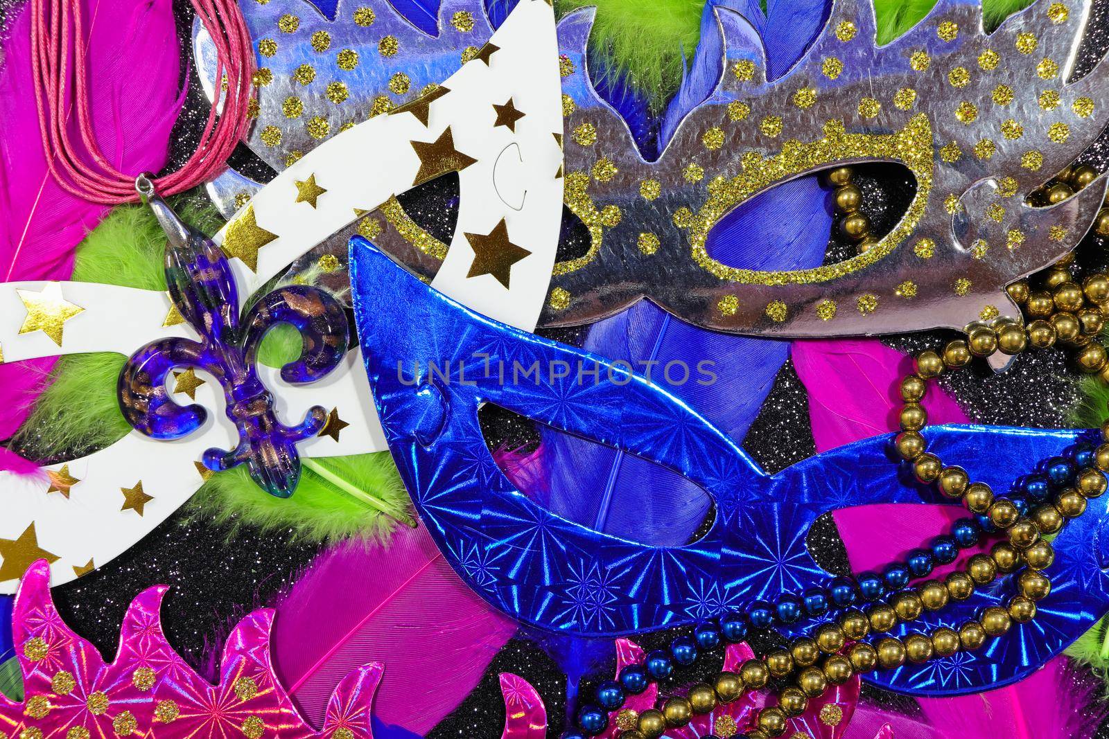 Mardi Gras carnival theme parade flat face masks with feathers and jewelry layout on textured black